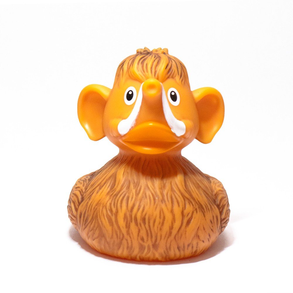 Pato de goma Mamut, con cuerpo anaranjado, orejas grandes y colmillos blancos, una divertida mezcla prehistórica.